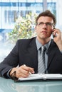 Businessman on call taking notes Royalty Free Stock Photo