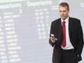 Businessman calling on mobile phone on airport Royalty Free Stock Photo