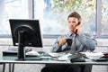 Businessman calling at office with mug Royalty Free Stock Photo