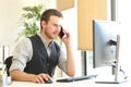 Businessman calling on phone and using a computer