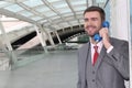 Businessman calling by public phone at the airport Royalty Free Stock Photo