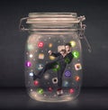 Businessman captured in a glass jar with colourful app icons con