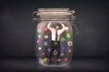 Businessman captured in a glass jar with colourful app icons con