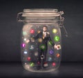 Businessman captured in a glass jar with colourful app icons con