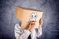 Businessman with cardboard box on his head and sad face expression Royalty Free Stock Photo