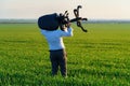 Businessman carries an office chair in a field to work, freelance and business concept, green grass and blue sky as background