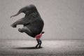 Businessman carry elephant on grey Royalty Free Stock Photo