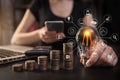 Businessman carry light bulbs with the idea of saving money, working with laptops. Royalty Free Stock Photo