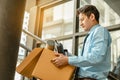 Businessman is carrying a brown cardboard box to resignation Royalty Free Stock Photo