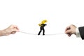 Businessman carrying dollar sign balancing tightrope with hands