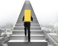 Businessman carrying gold bullion on stairs with urban scene Royalty Free Stock Photo