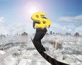 Businessman carrying gold dollar sign balancing on wire Royalty Free Stock Photo