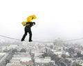 Businessman carrying golden dollar sign balancing on tightrope Royalty Free Stock Photo