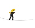 Businessman carrying golden dollar sign balancing on tightrope Royalty Free Stock Photo