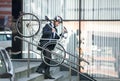 Businessman carrying his bike Royalty Free Stock Photo