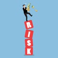 Businessman carrying his money on shaky risk blocks