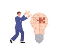 Businessman cartoon character assembling puzzle pieces into idea lamp lightbulb to solve problem