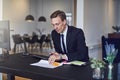 Businessman catching up on paperwork at his office desk