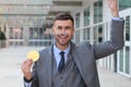 Businessman celebrating while holding a Bitcoin Royalty Free Stock Photo