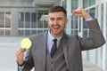 Businessman celebrating while holding a Bitcoin Royalty Free Stock Photo