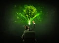 Businessman in chair sitting in front of a glowing tree Royalty Free Stock Photo