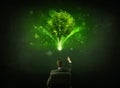 Businessman in chair sitting in front of a glowing tree Royalty Free Stock Photo