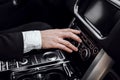 Businessman changing radio station while driving automobile Royalty Free Stock Photo