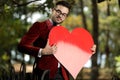 Businessman charged with emotions holding big red heart Royalty Free Stock Photo