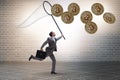 Businessman chasing bitcoins in cryptocurrency concept