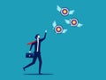 Businessman chasing a target flying away from him. Failing goals and finding goals. business concept