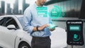 Businessman check battery status from smartphone hologram. Peruse