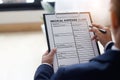 Businessman checking document and completing a insurance claim form at office work, insurance protection concept Royalty Free Stock Photo