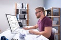 Businessman Checking Invoice On Computer