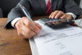 Businessman Checking Receipts At Desk Royalty Free Stock Photo
