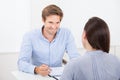 Businessman checking resume of female candidate during meeting