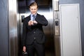 Businessman checking time in elevator Royalty Free Stock Photo