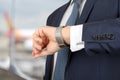 Businessman checking time on his watch at the airport Royalty Free Stock Photo