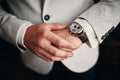 Businessman checking time on his wrist watch, groom getting ready in the morning before wedding ceremony