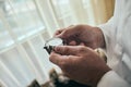 Businessman checking time on his wrist watch, man putting clock on hand,groom getting ready in the morning before wedding ceremony Royalty Free Stock Photo