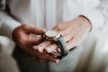 Businessman checking time on his wrist watch, man putting clock on hand,groom getting ready in the morning before wedding ceremony Royalty Free Stock Photo