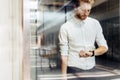 Businessman checking watch while standing in elevator Royalty Free Stock Photo