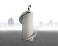 Businessman cheering on concrete spiral tower