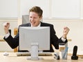 Businessman cheering at Desk Royalty Free Stock Photo