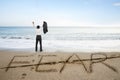 Businessman cheering with fear word deleted line on sand beach Royalty Free Stock Photo