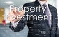 the businessman is choosing Property Investment from touch scree