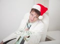 Businessman in Christmas cap gives us money