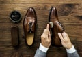 Businessman cleaning his shoes with a brush Royalty Free Stock Photo