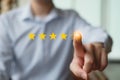 Businessman click on five yellow stars to increase rating.