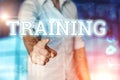 Businessman clicks on a virtual screen and selects TRAINING. Blue background. Business concept. Mixed media Royalty Free Stock Photo
