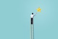 Businessman climb up on ladder to reach star, successful and win concept Royalty Free Stock Photo